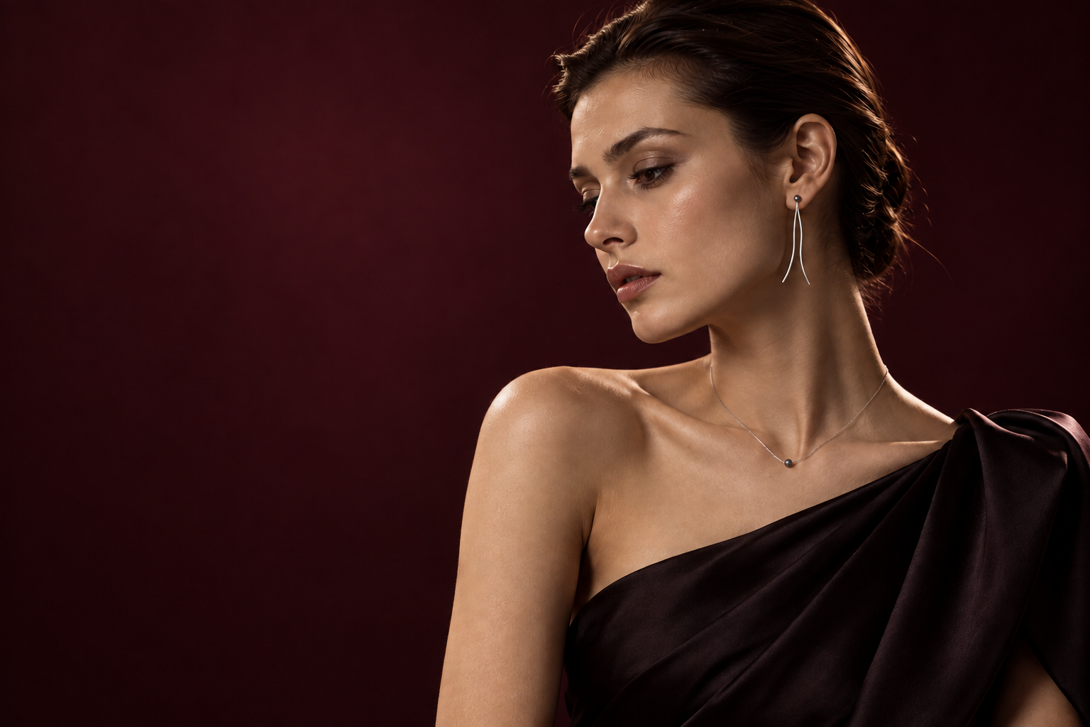 Vesper campaign: a dramatic evening studio portrait with fine silver thread earrings, black silk and a burgundy backdrop